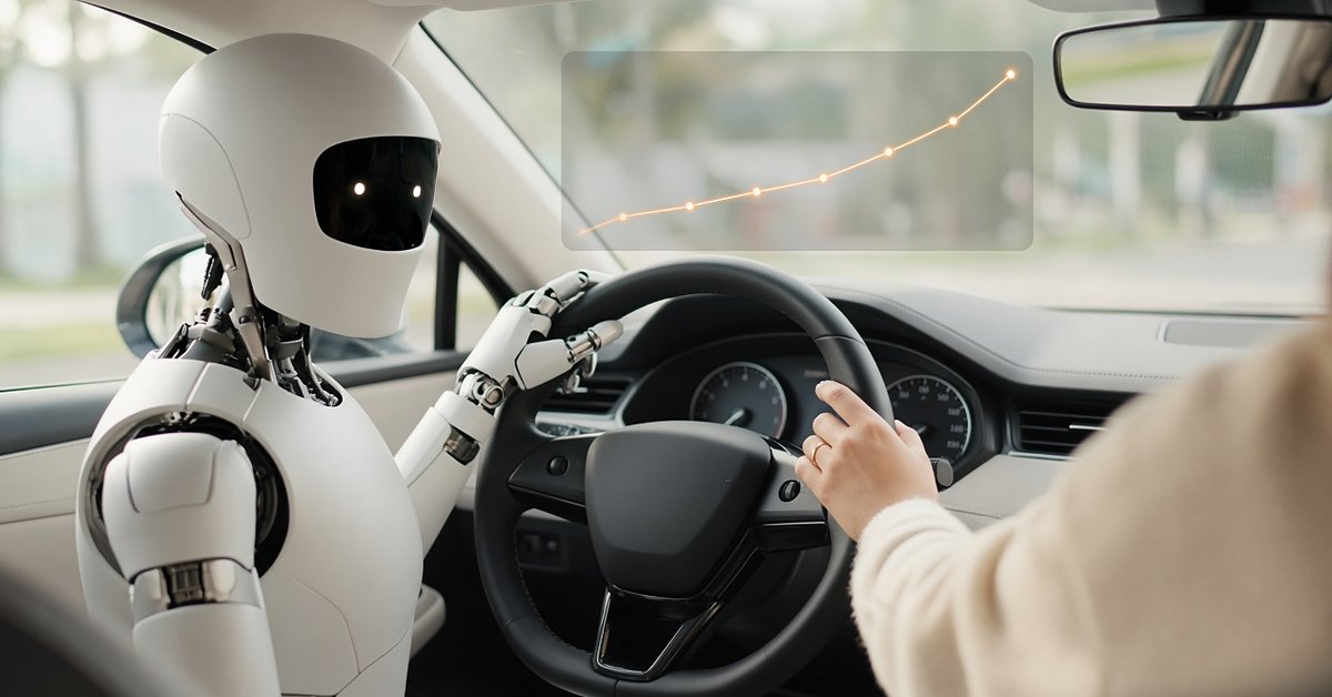 A white humanoid robot in the driver's seat holds the steering wheel while a woman in a cream knit sweater keeps her hand on the same wheel, with a soft rising performance line on the windshield.